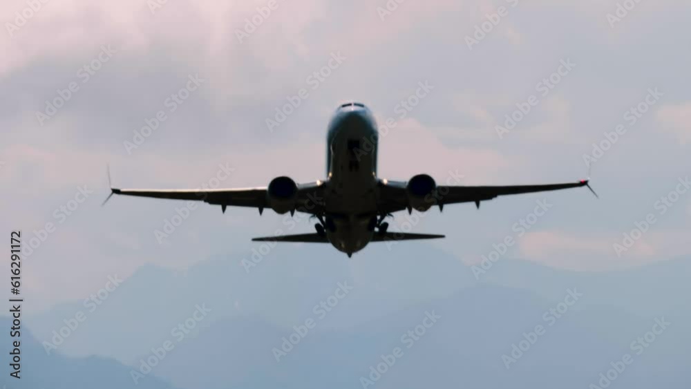 Departing large passenger airplane, airliner silhouette is taking off, flying in the dramatic cloudy sky over mountains. Contrast look, transportation, dark, mystery, gloomy and flight concept Departing large passenger airplane, airliner silhouette is taking off, flying in the dramatic cloudy sky over mountains. Contrast look, transportation, dark, mystery, gloomy and flight concept