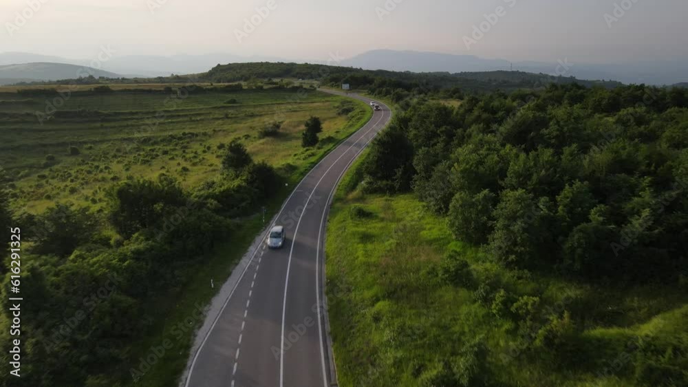 Aerial Drone View Car Driving on Curvy Mountain asphalt Road in summer Aerial Drone View Car Driving on Curvy Mountain asphalt Road in summer