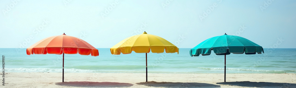 A few colorful parasols, umbrellas on a sunny beach