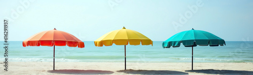 A few colorful parasols, umbrellas on a sunny beach © tania_wild