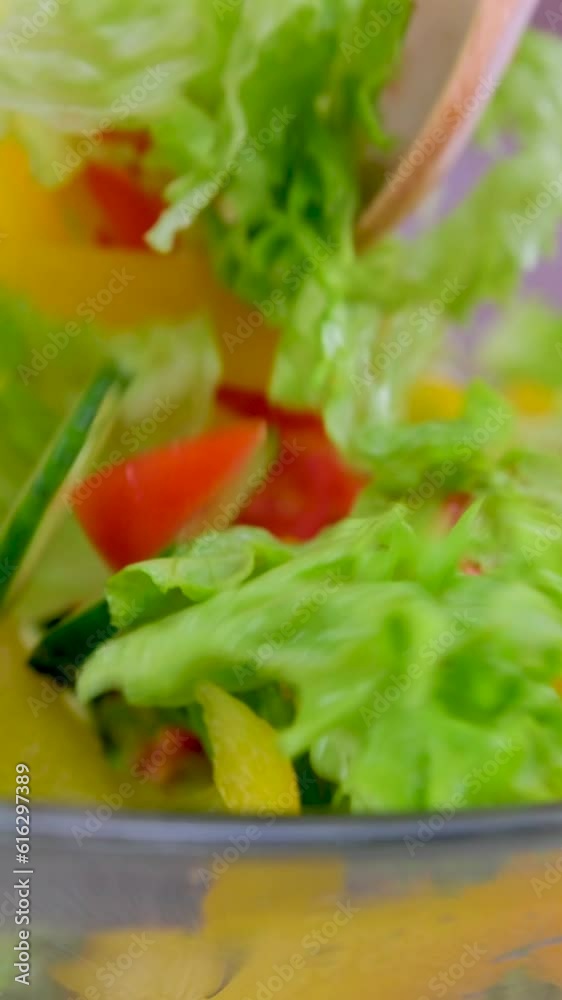 vegetable salad from a glass plate with a wooden spatula stir vegetables Balanced diet, healthy food concept on wooden board. View from above. High quality photo vegetable salad from a glass plate with a wooden spatula stir vegetables Balanced diet, healthy food concept on wooden board. View from above. High quality photo