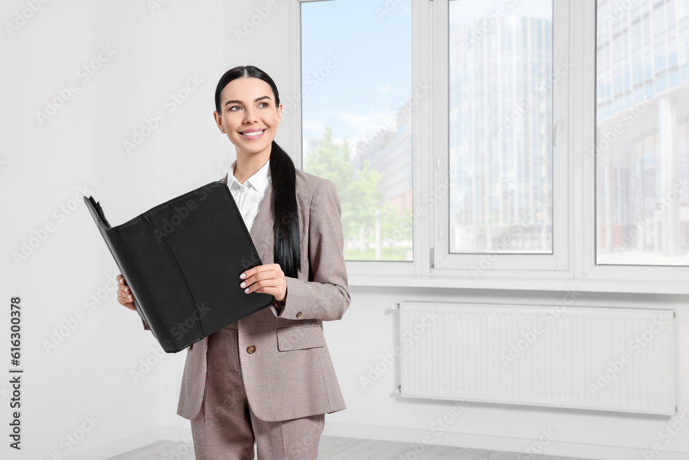 Beautiful real estate agent with documents indoors, space for text Beautiful real estate agent with documents indoors, space for text