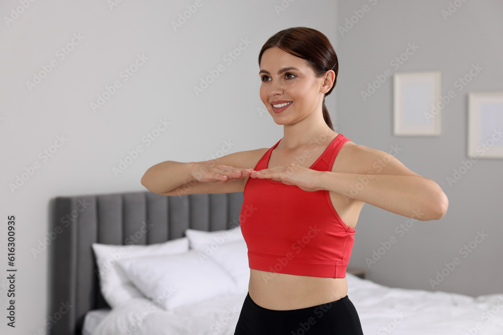 Happy woman doing morning exercise at home, space for text Happy woman doing morning exercise at home, space for text