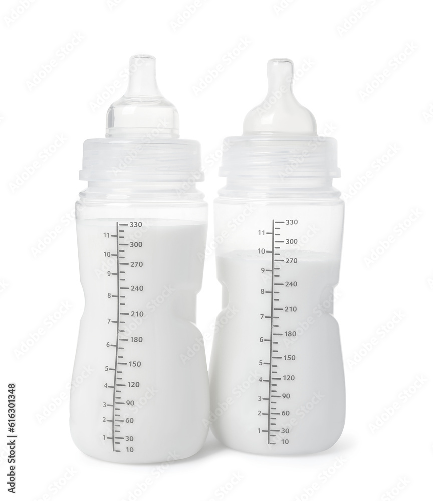 Two feeding bottles with infant formula on white background Two feeding bottles with infant formula on white background
