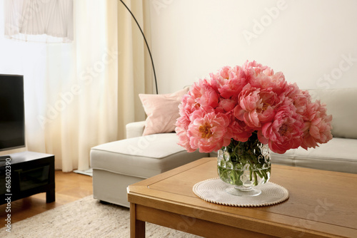Fototapeta Naklejka Na Ścianę i Meble -  Beautiful pink peonies in vase on table at home, space for text. Interior design