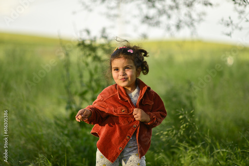 little girl playing and having fun by the river