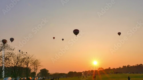 .Chiang Rai,Thailand - February 18,2018:sweet sunrise on the back of .colorful hot air balloons festival at Singha Park in Chiang Rai. .scenery sunrise flying colorful ballon background..