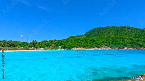 Kho Rasha island off the coast of phuket thailand by speed bias from Chalong Bay, beautiful turquoise Blue beach with white soft sand and lush green trees  © Elias Bitar