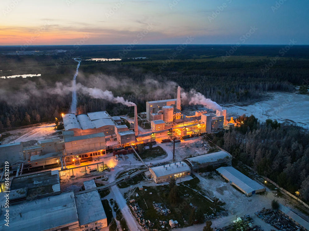 Illuminated plant buildings of silica manufacturing at night