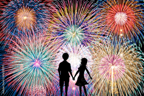 Silhouette of a couple staring at fireworks. Fireworks date concept.