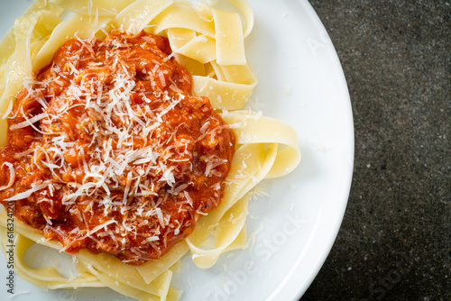 pork bolognese fettuccine pasta with parmesan cheese