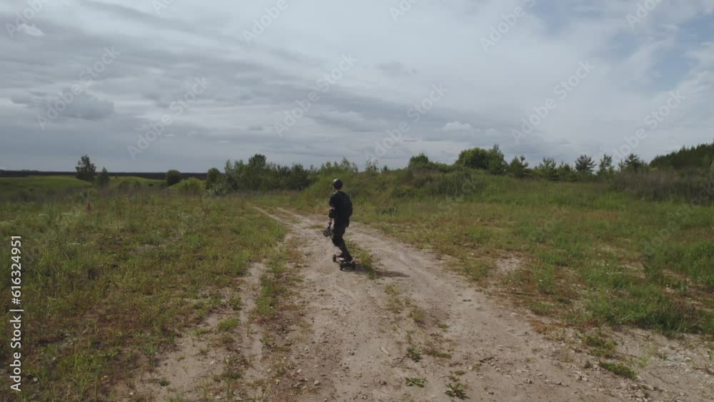 Aerial photography of a skateboarder in nature, a man on an electric skateboard, riding an electric skateboard in nature, electric longboard evolve, electric skateboard evolve