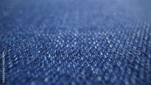 The structure of the fabric. Close-up of blue denim fabric. Dolly shot