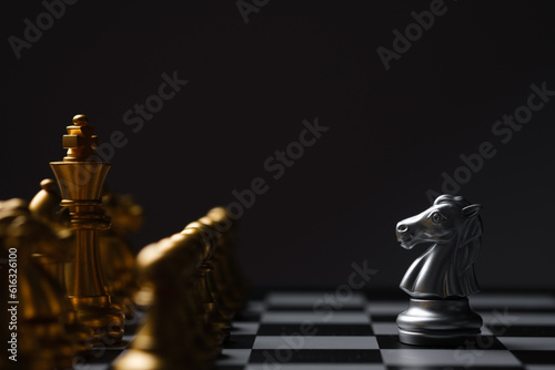horse stand with enemy chess pieces on chess board game competition with dark background, chess battle, victory, success, team leader, teamwork, business strategy concept