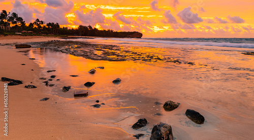 Cloud Filled Sunrise Reflecting on Tide Pools., Shipwreck Beach, Kauai, Hawaii, USA