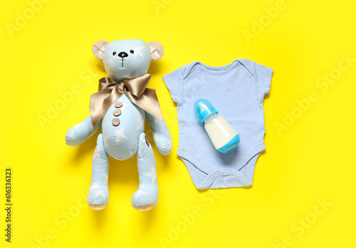 Teddy bear with bottle of m...