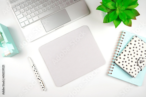Mouse pad mockup. Styled with computer keyboard and modern desktop accessories. Negative copy space.