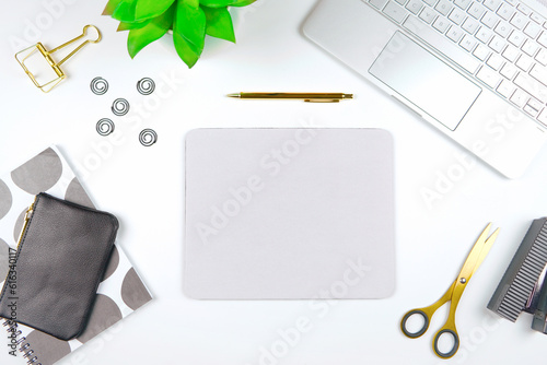 Mouse pad mockup. Styled with computer keyboard and modern desktop accessories. Negative copy space.