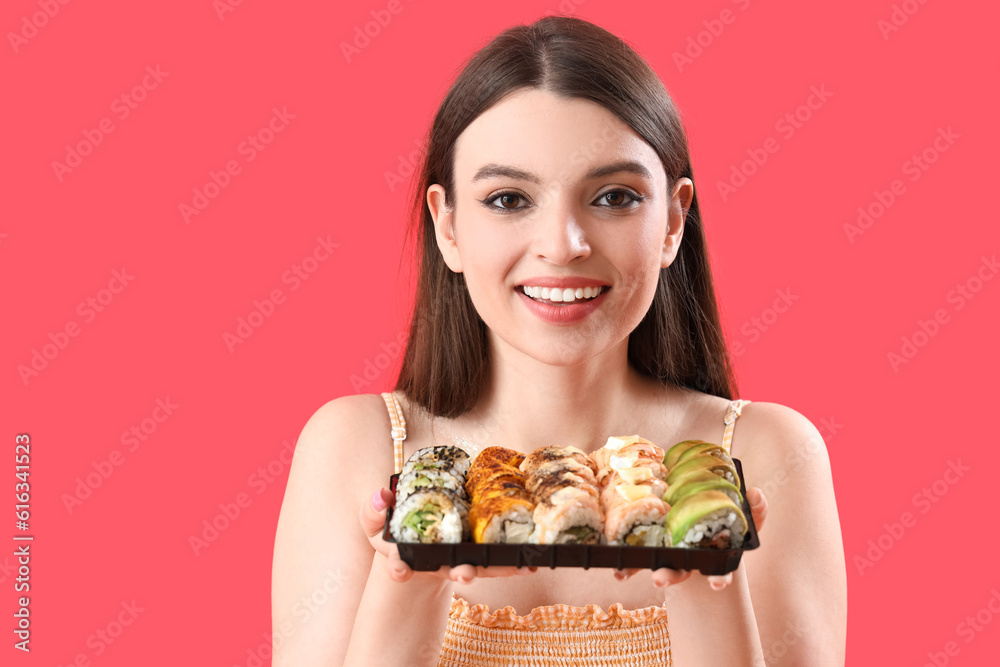Young woman with sushi on red background, closeup Young woman with sushi on red background, closeup