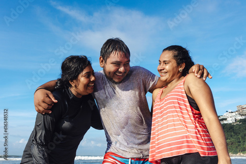 Happy latin friends teenagers at beach having fun at pacific ocean in Acapulco Mexico Latin America, hispanic people