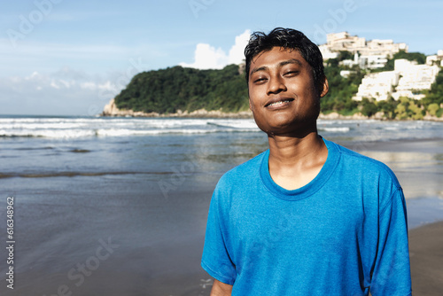 portrait of young latin man at beach in Acapulco Mexico Latin America, hispanic people at pacific ocean