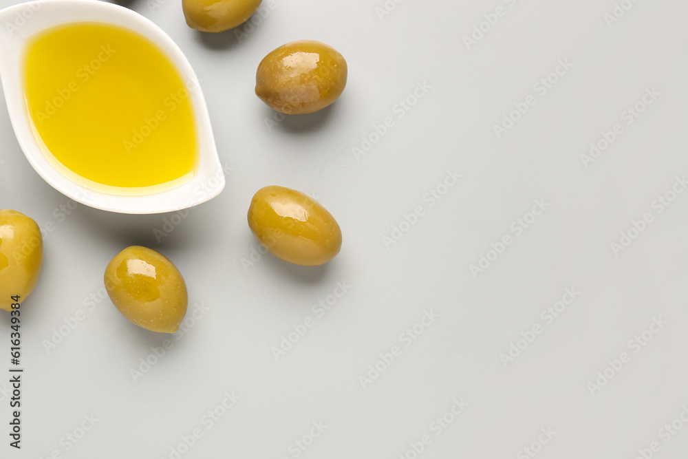 Bowl with fresh olive oil on grey background Bowl with fresh olive oil on grey background