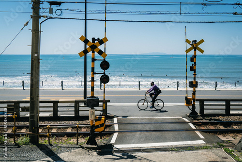 Cyclist Riding Coastline Alongside Railway on a Summers Day  photo
