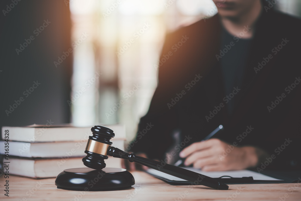 concept of law and justice ,legal contract consulting ,court proceedings ,planning for court proceedings ,Wooden judge gavel on table ,justice in punishment of offenses and criminal verdicts