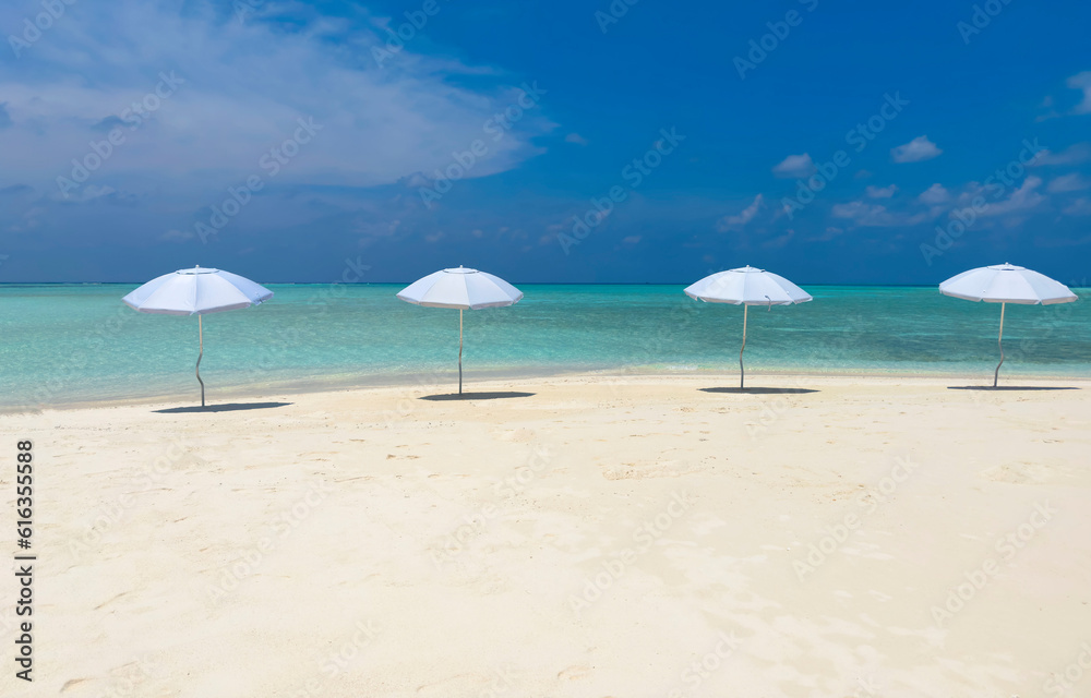  Summer tropical with white umbrella on the beach with  blue sky background