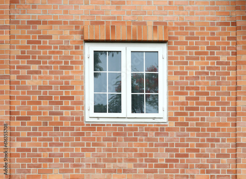 Classic white windows on brick wall facade.