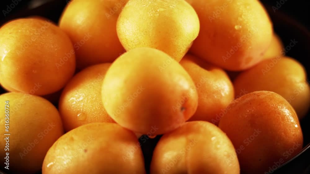 Ripe apricots rotate on a black background Ripe apricots rotate on a black background