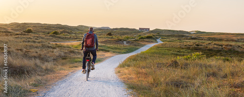 Cyling during dusk to the beach of Formerum at Wadden island Terschelling Friesland province in The Netherlands photo