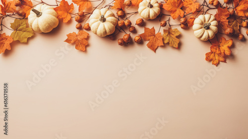 Autumn leaves and pumpkins on a beige background. Minimal Thanksgiving concept. Flat lay