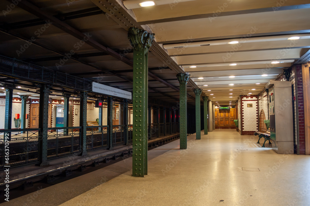 Naklejka premium Budapest, Hungary - Metro station, platform with old columns, rails and tiles on the walls.