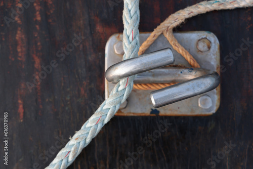 White rope attached to stainless steel on the boat