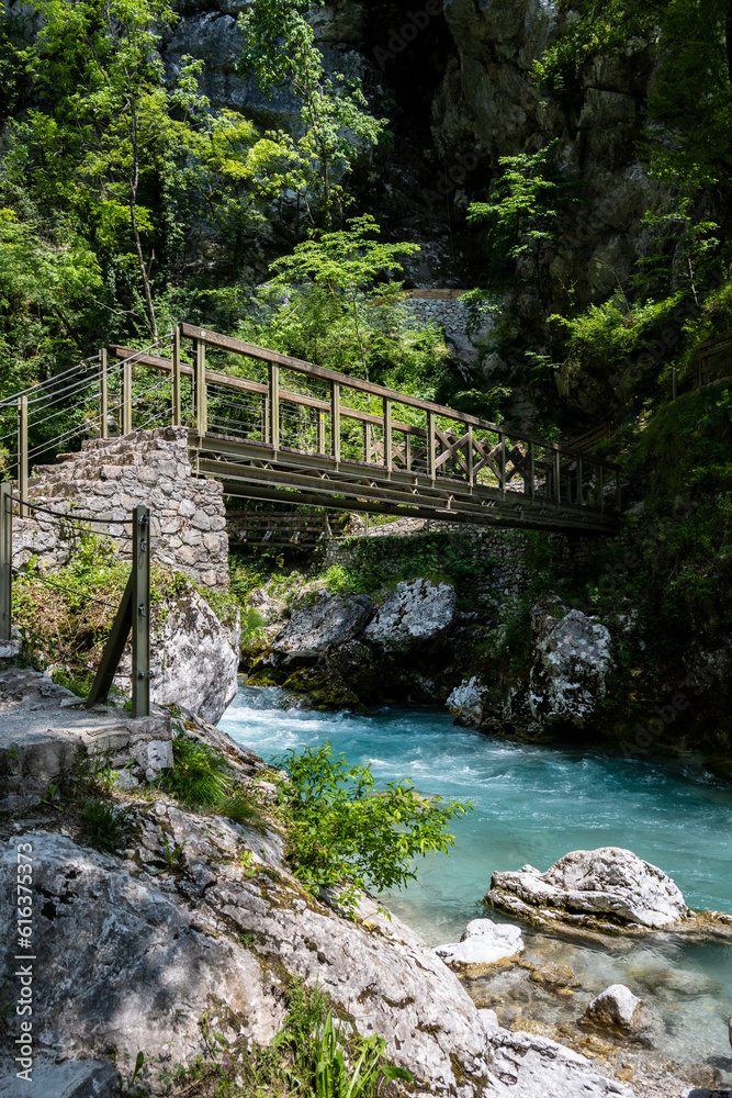 Beautiful, turquoise Soca river, passing under the old, wooden bridge, deep in the slovenian Alps mountains Beautiful, turquoise Soca river, passing under the old, wooden bridge, deep in the slovenian Alps mountains