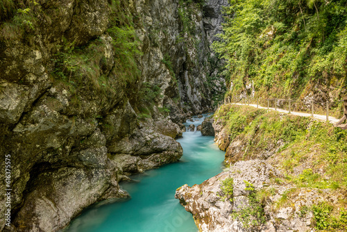 Wonderful landscape of turquoise Soca river, Slovenia, passing through amazing, steep, rocky canyon of slovenian Alps, covered in dense vegetation