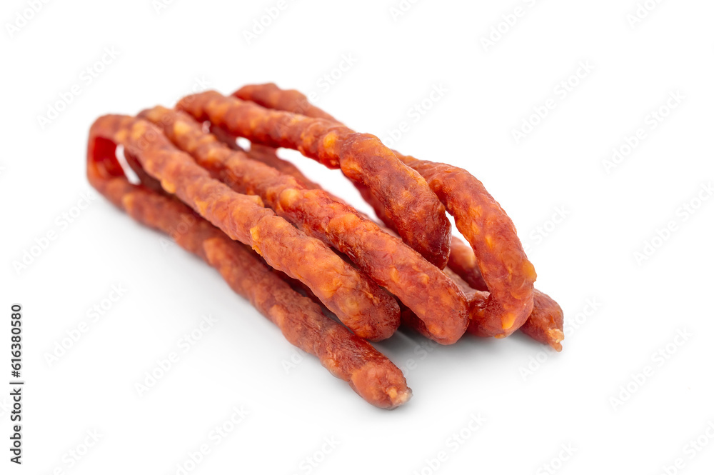 Dried thin meat sausages for beer on a white background.