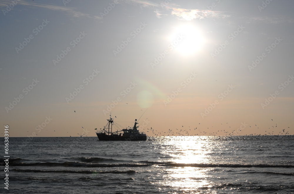 Trawler at sunset off the Dutch coast