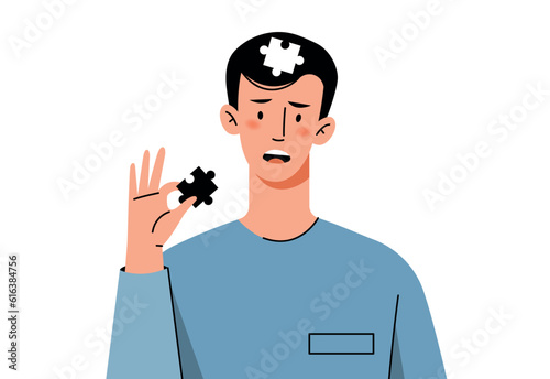 A young man puts together a puzzle in his head. The concept of self-development and self-discovery.Problems of human mental health.