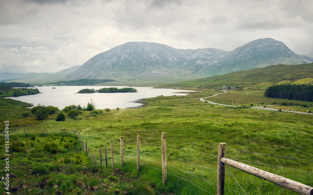 Beautiful cloudy lakeside landscape scenery of lake and mountains at Lough Inagh, connemara national Park in County Galway, Ireland 