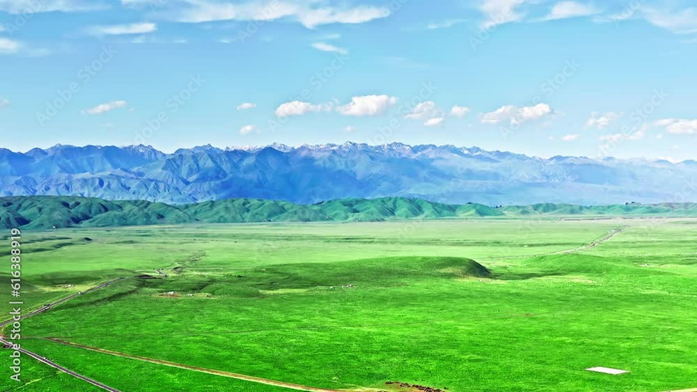 Aerial view of green grassland and mountain natural landscape in Xinjiang, China. Aerial view of green grassland and mountain natural landscape in Xinjiang, China.