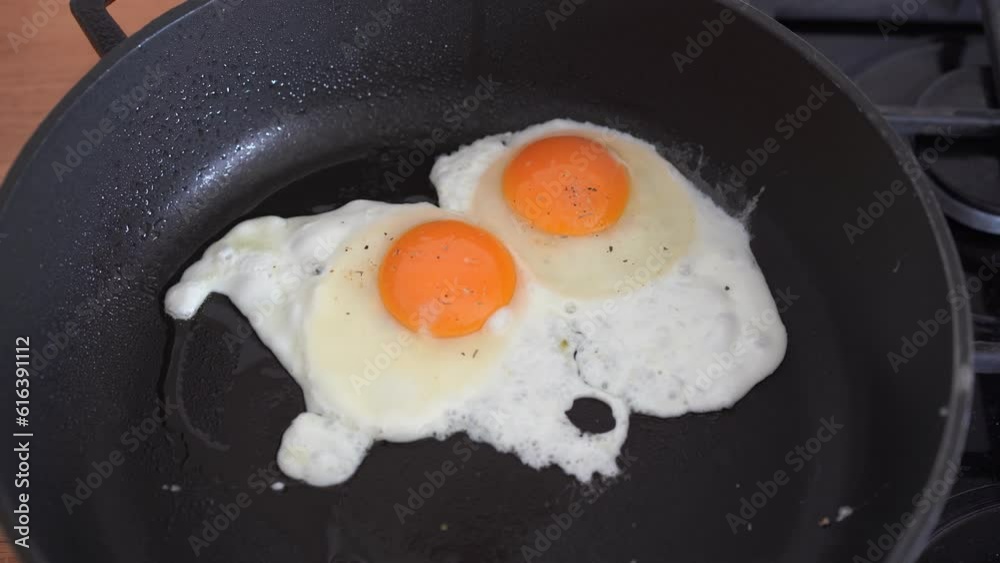 Frying eggs on hot pan at home kitchen. High quality 4k footage Frying eggs on hot pan at home kitchen. High quality 4k footage
