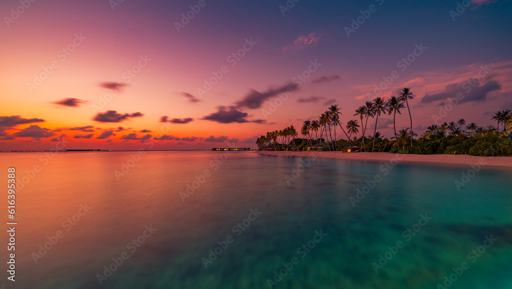 Beautiful panoramic sunset tropical paradise beach. Tranquil summer vacation holiday landscape. Tropical sunset beach coast palms. Calm sea sky panorama. Exotic island nature inspire seascape scenic