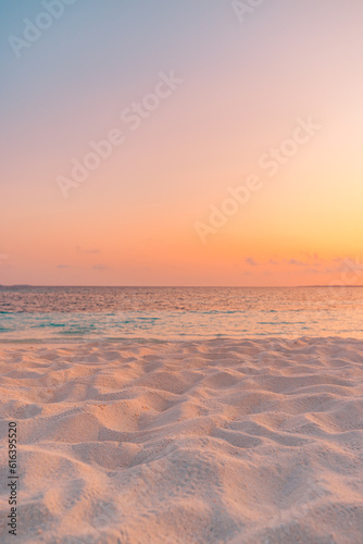 Closeup beach coast sand texture with warm gold orange sunset light. Fantasy beach landscape sky sea bay. Tranquil relax bright horizon, colorful sky. Peaceful nature seascape. Summer Mediterranean