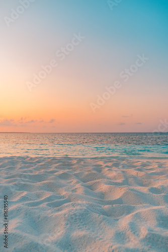 Fototapeta Naklejka Na Ścianę i Meble -  Closeup beach coast sand texture with warm gold orange sunset light. Fantasy beach landscape sky sea bay. Tranquil relax bright horizon, colorful sky. Peaceful nature seascape. Summer Mediterranean