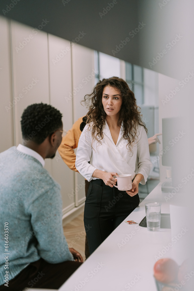 Serious gorgeous business girl having a conversation with her male colleague at work Serious gorgeous business girl having a conversation with her male colleague at work