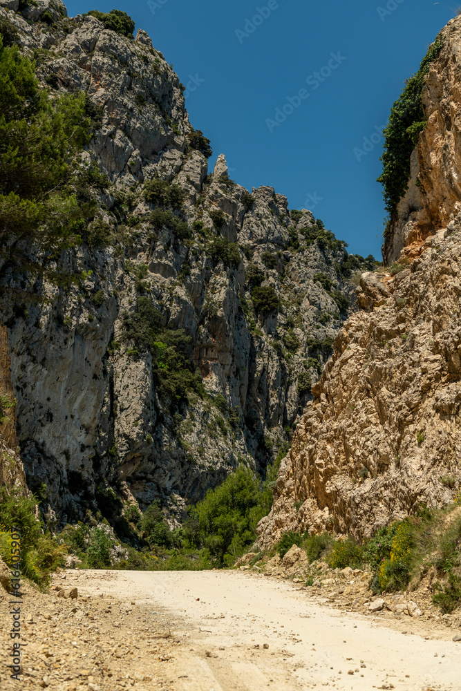 Pass del Comptador, the pass between Sella and Guadalest, small gravel mountain road used by cyclists, Costa Blanca, Alicante, Spain  - stock photo
