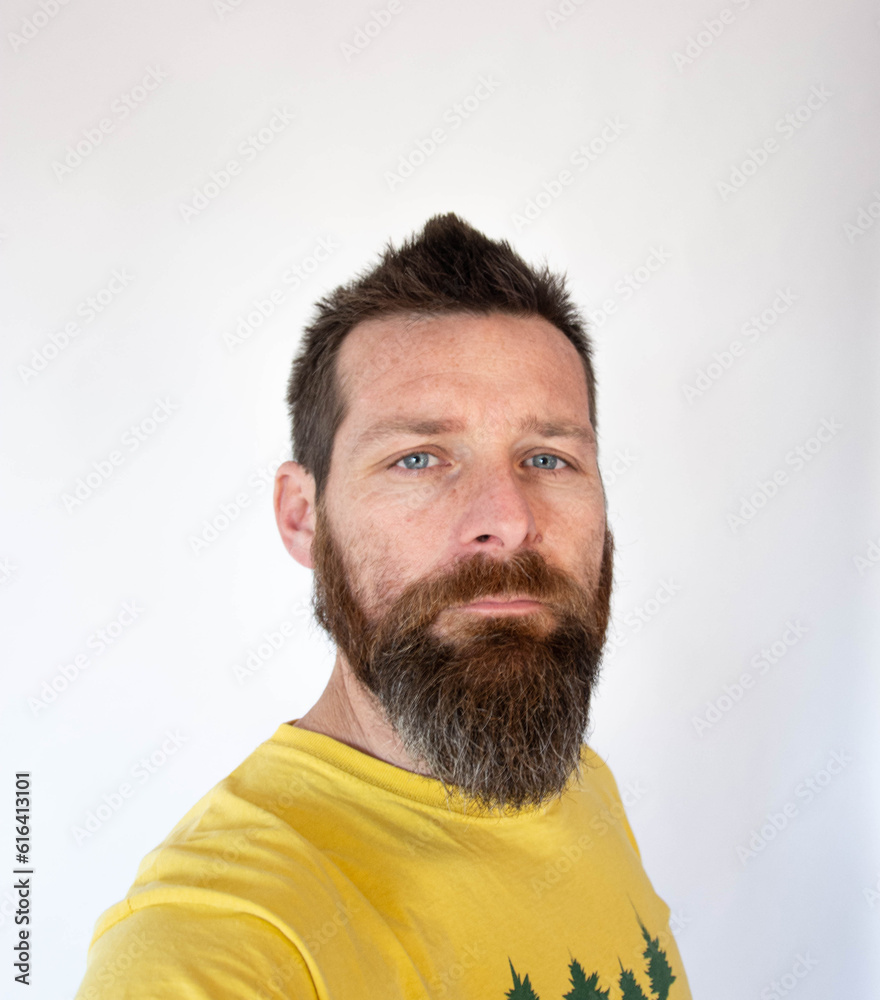 Fototapeta premium bearded man in yellow polo in white background