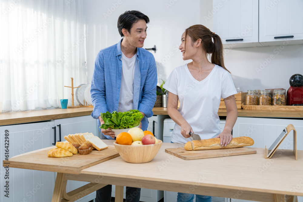 young couple happily makes breakfast and sweet treats together.